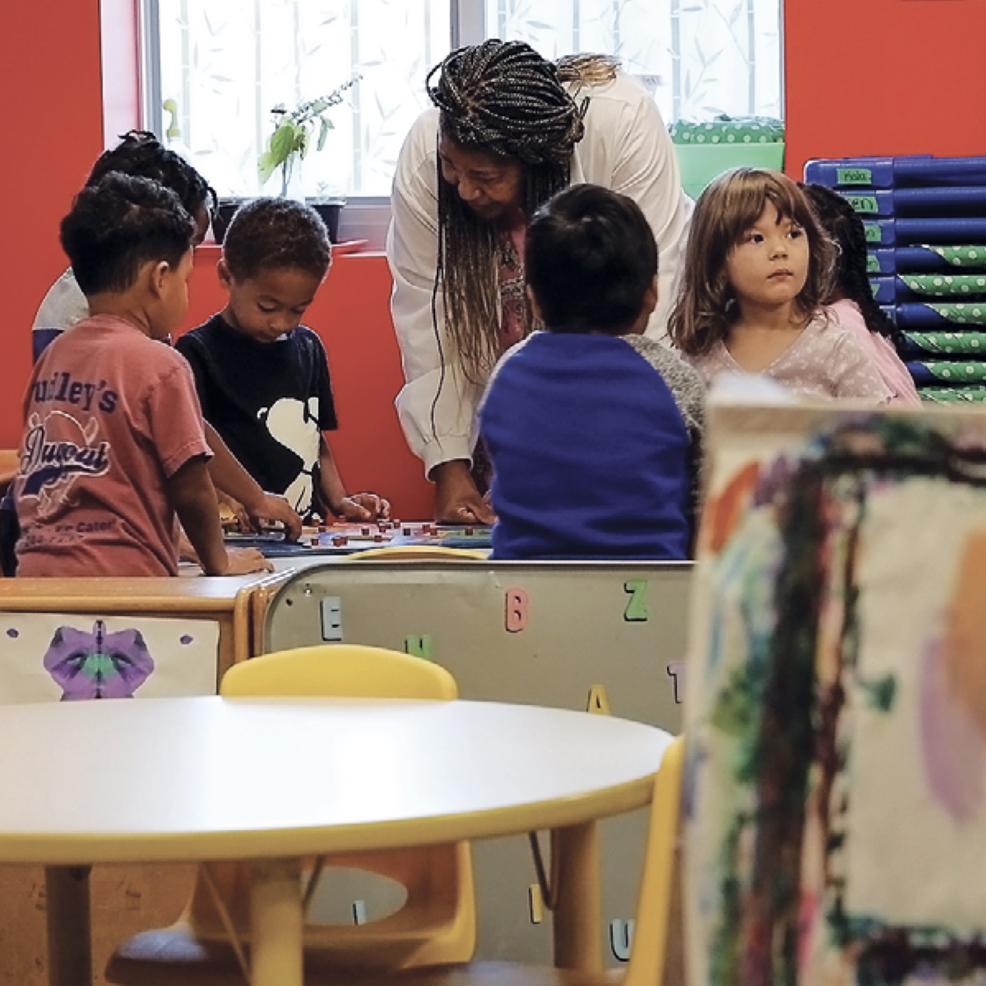 Pre-K Teacher with children at table